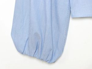 Detail of blue and white striped poplin shirt showing lantern sleeve and elastic cuffs