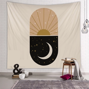 Modern bohemian tapestry with sun and moon pattern hanging on a white brick wall