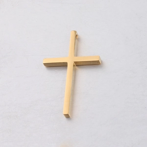 Macro shot of mirror-polished gold stainless steel cross pendant with smooth metallic finish