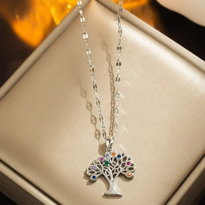 Colorful tree of life pendant necklace with cubic zirconia on a beige jewelry display