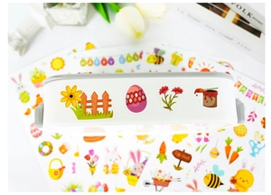 Close-up of colorful Easter stickers with bunnies and eggs on a white storage box