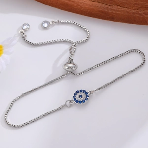 Close-up of adjustable silver Evil Eye bracelet with blue and white sparkling crystals