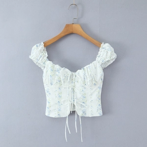 Detail of floral puff sleeve top with tie-up bust and vintage blue flower pattern