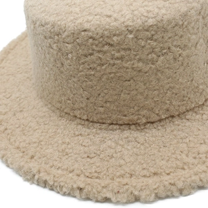 Close-up of beige teddy fleece bucket hat showing soft sherpa texture and detail