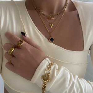 Layered gold-plated heart pendant necklaces and matching jewelry set worn by model