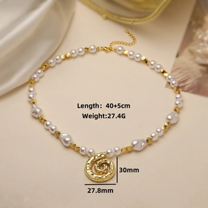 Detail view of pearl necklace with golden spiral shell pendant and size specifications