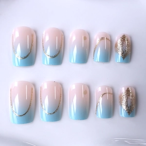 Blue gradient press-on nails with golden glitter lines and elegant diamond pattern