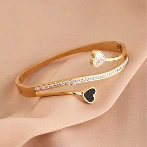 Elegant gold titanium steel double-layer open bangle with heart charms and pavé zircon
