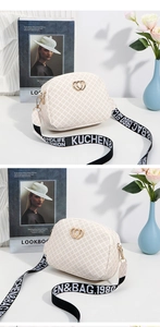 Macro detail of cream small square bag with heart buckle and branded webbed strap