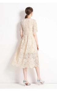 Detail eines bestickten Spitzenkleides mit Fokus auf Rückenschnitt und Blumenstruktur