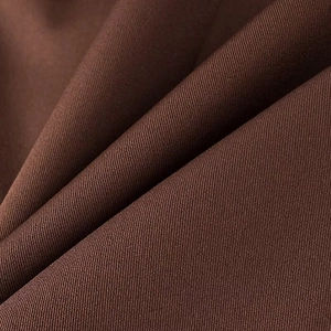 Gros plan sur la texture du tissu sergé marron foncé épais pour ce blazer pour femmes