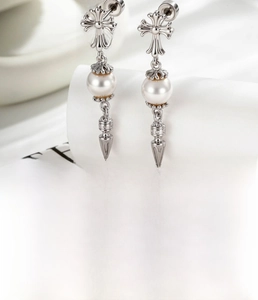 Detailed view of silver cross pearl stud earring made of titanium steel and cubic zirconia