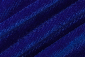Detailed macro view of luxurious royal blue velvet fabric with soft light reflections