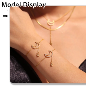 Close-up of gold double-layer necklace and bracelet set with crescent moon and star charms