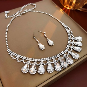 Detail of silver drop fringe necklace and matching earrings set with sparkling crystals