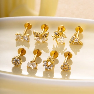 Set of 8 gold stainless steel labret studs with butterfly and crystal designs