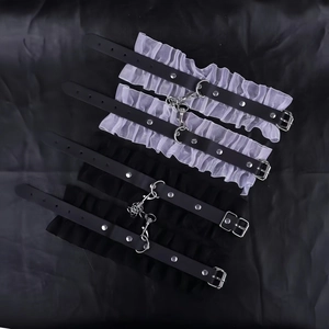Detail of four lace and leather garters with metal chains for punk maid costumes