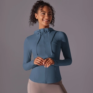 Detail of greyish blue hooded sports jacket featuring a slim fit and smooth nylon texture