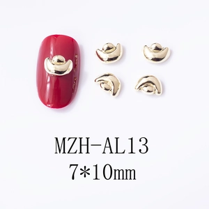 Macro view of gold ingot nail charms and size details for festive manicure design