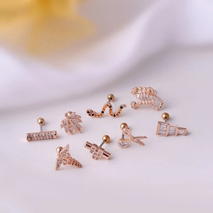 Rose gold titanium steel cartilage earrings featuring snake, leaf, and scorpion designs