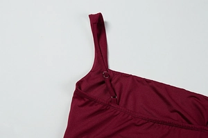 Detail of adjustable wine red spaghetti straps with silver metal buckles on a dress