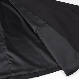 Detailed macro view of the inner lining and precise stitching on black blazer jacket