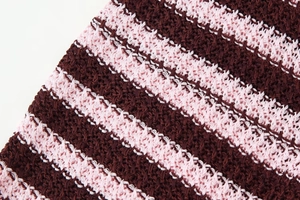 Macro shot of striped knit texture in pink and burgundy for short-sleeve cardigan set