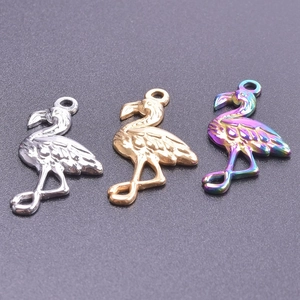 Three-color flamingo pendants in gold, silver, and iridescent finish with detailed feathers