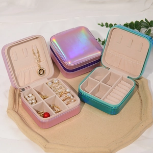 Portable jewelry organizer with rings slots and necklace hooks in pink and green