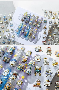 Macro detail of cartoon duck nail stickers with glossy finish and vibrant floral patterns