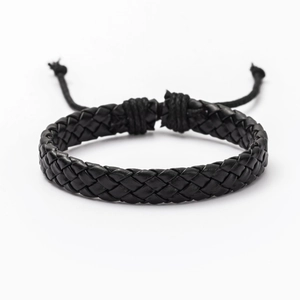 Close-up of black braided leather bracelet featuring adjustable drawstring and woven design
