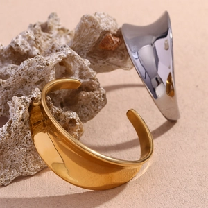 Minimalist wavy 18K gold and silver plated stainless steel open bangles on stone
