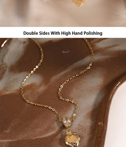 Detail of strawberry pendant with clear zircon on polished gold stainless steel chain