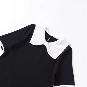 Short sleeve knit top with a white contrast Peter Pan collar and bow accent in black