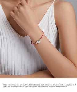 Close-up of pink woven leather bracelet with a S925 silver clover clasp on a wrist