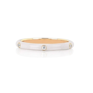 Close-up of slim white enamel ring with 18K gold plating and three inset cubic zirconia