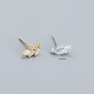 Macro view of 8.2mm silver and gold flower petal earrings with leaf crystal inlay