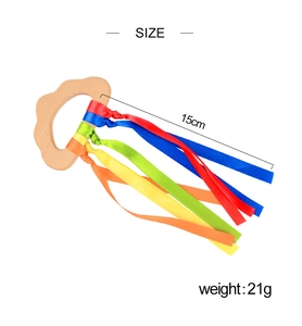 Detailed size and weight view of a wooden sensory ring toy with colorful silk ribbons