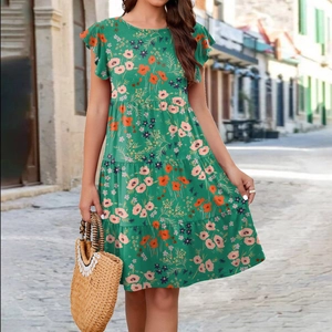 Close-up of green floral dress with ruffled sleeves and tiered layers on European street