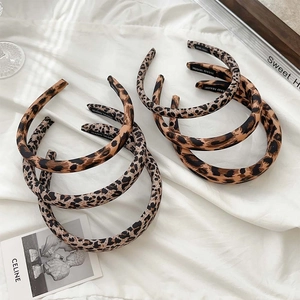 Set of 6 leopard print sponge headbands in light and dark patterns on white fabric
