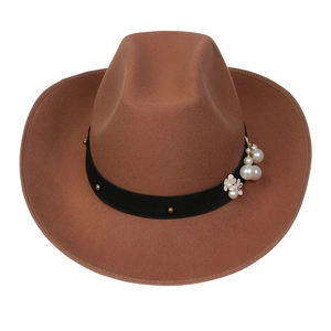 Detail of a brown wool felt cowboy hat featuring pearl floral accents and black ribbon band
