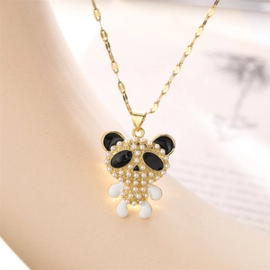 Close-up of golden panda pendant with inlaid pearls and black enamel detailing