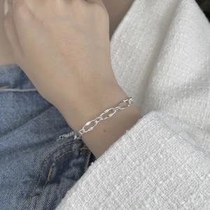 Close-up of S925 sterling silver lip-shaped chain bracelet on a model's wrist