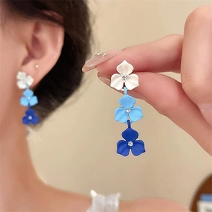 Detail of blue gradient triple flower earrings featuring sparkling rhinestone centers