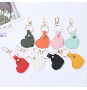 Flat lay of colorful heart-shaped leather keychains with gold metal rings and lobster clasps