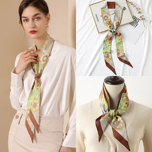 Macro detail of silk-like twilly scarf with vintage floral and chain patterns