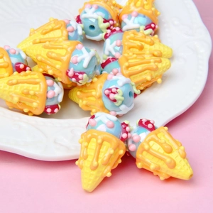 Detailed view of colorful ice cream cone resin beads with vibrant toppings on a plate