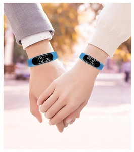 Close-up of couples wearing blue waterproof LED sports watches in an outdoor setting