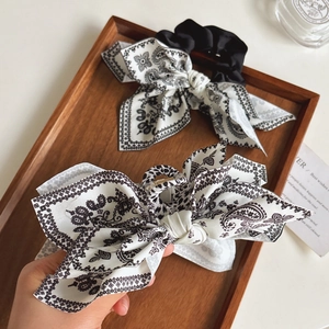 Elegant set with paisley bow hair clip and scrunchie in classic black and white style