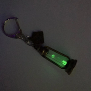 Close-up of vintage kerosene lamp pendant glowing green light in a dark setting